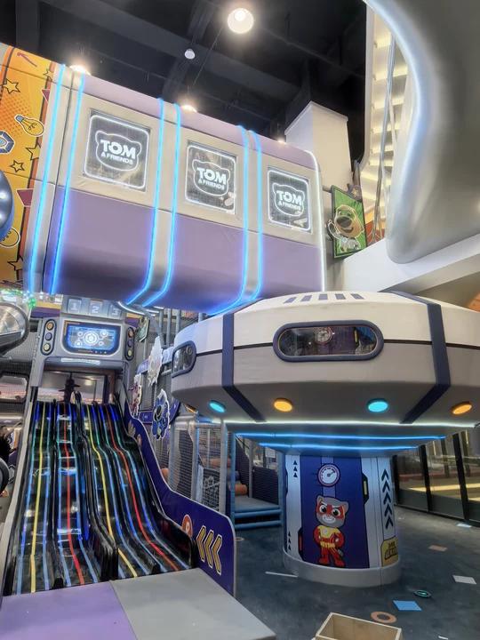 Installed multi-level play structure with illuminated racing slide