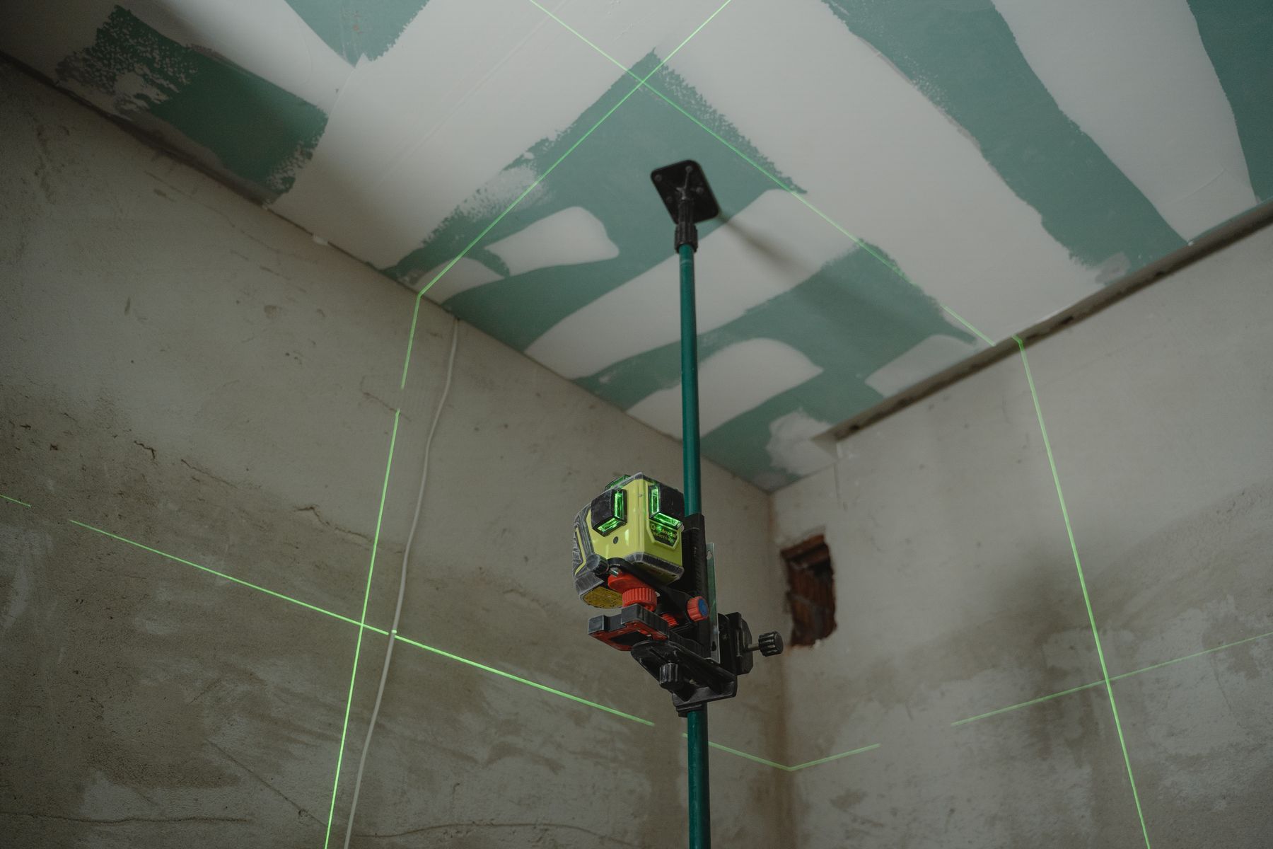 Laser level measuring an unfinished interior for site feasibility review