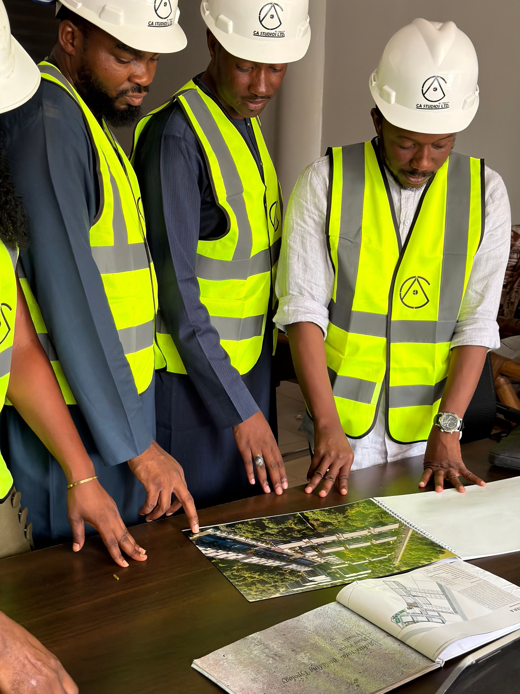 Project team reviewing plans and visual materials at a table